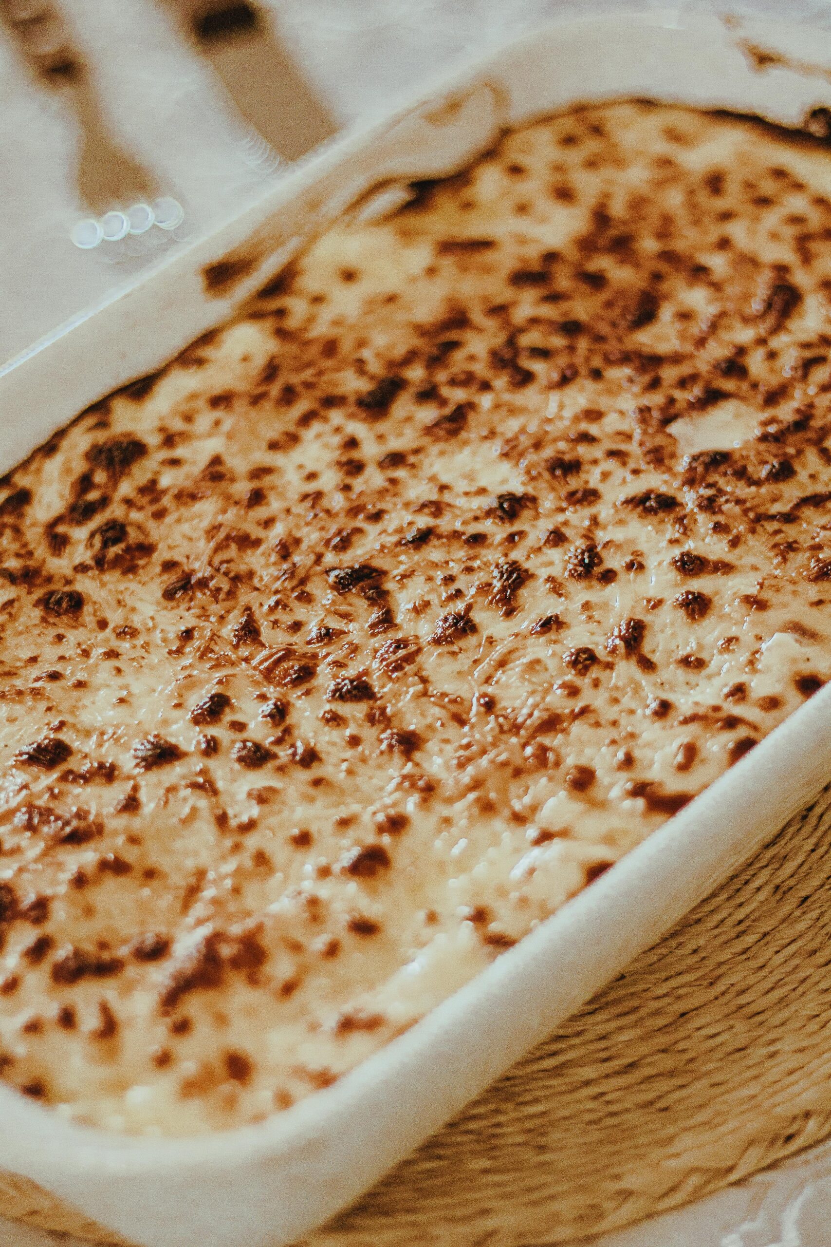 Creamy Negresco Pasta Bake topped with melted cheese, served in a baking dish, representing a comforting family favorite meal.